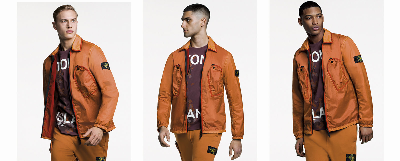 Model wearing shiny, two tone orange overshirt with diagonal pockets at chest and zipper fastening.