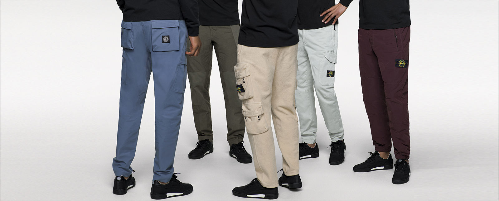 Five models wearing different styles of pants with different styles of pockets.