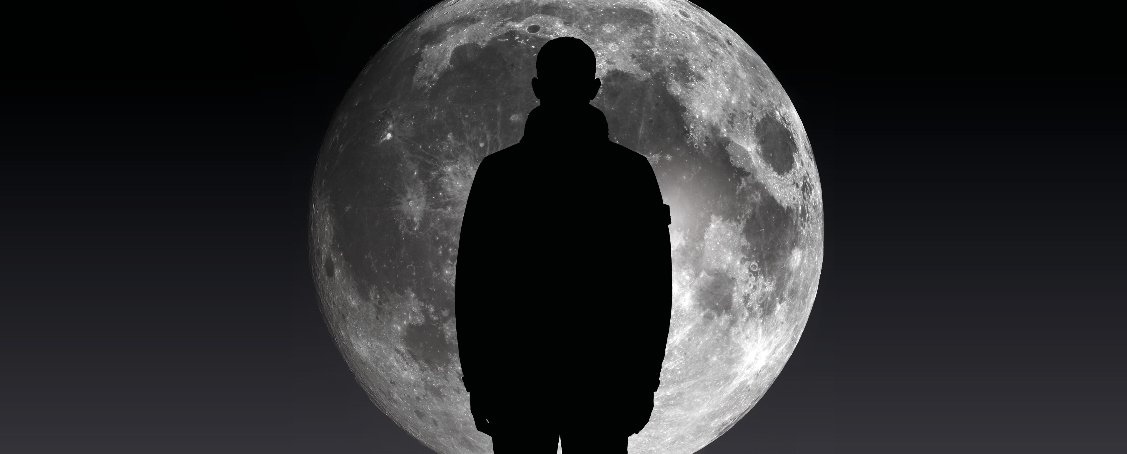 Model wearing a sportswear jacket, standing fully silhouetted against the moon