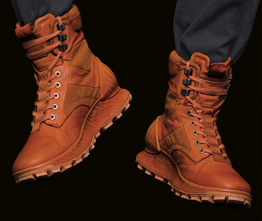 Rugged lace up ankle boots with tread soles in orange with monochrome laces