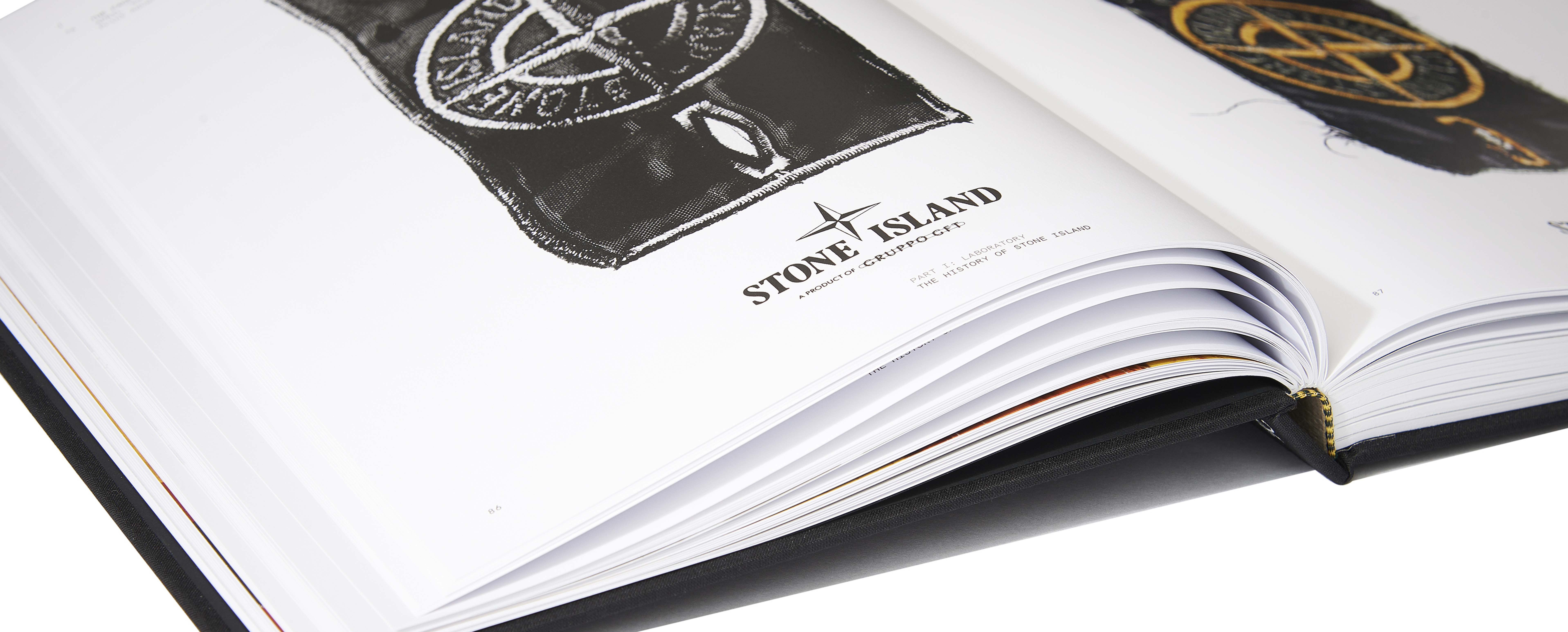 Close up image of an open hardcover book, showing detailed pictures of Stone Island badges and logos.