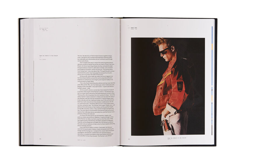 Still life image of an open hardcover book showing printed text on the left page and a model wearing white pants and a red jacket on the right page.