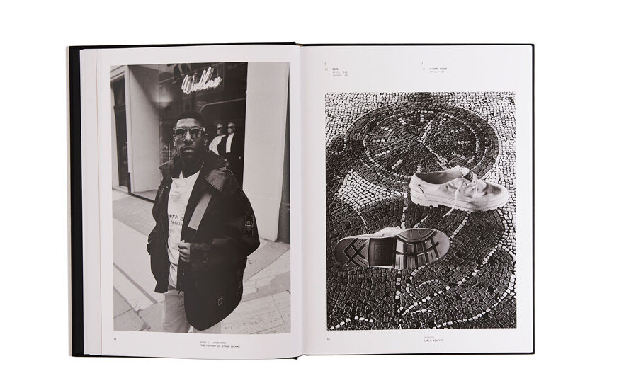 Still life image of an open hardcover book showing two black and white pictures, a man wearing a dark jacket on the left page and a pair of shoes placed on mosaic tiles on the right page.