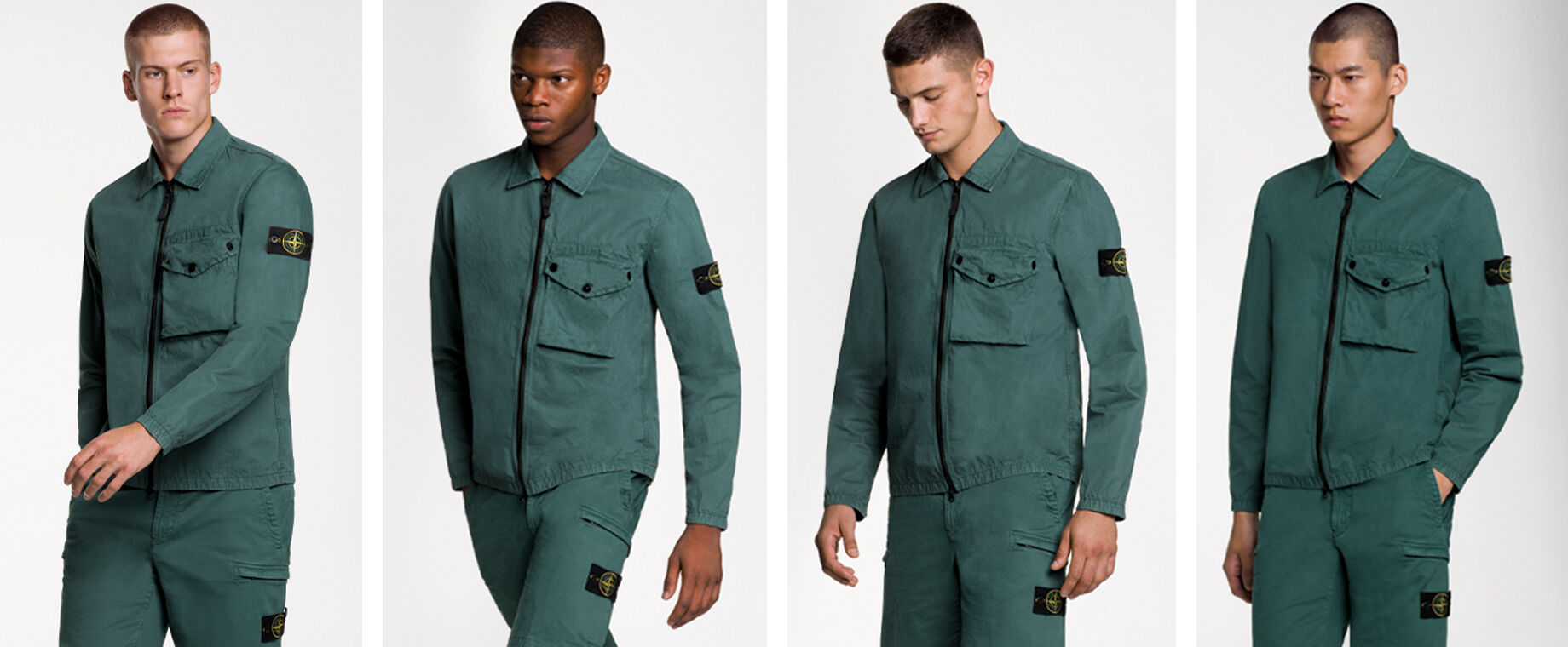 Four models wearing the same outfit, consisting of dark green shorts and a matching overshirt with two way zipper fastening, a bellows pocket with flap and snaps on the chest and the Stone Island badge on the upper left arm.