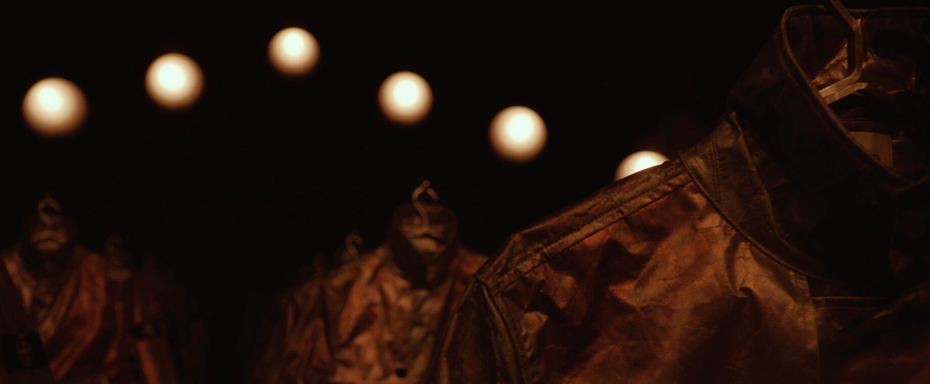 Stone Island Prototype Research Series 05 jackets displayed in a dark warehouse setting.