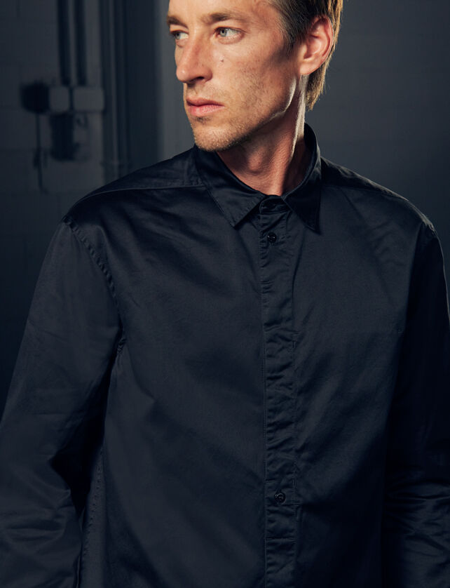 Model wearing a black shirt.